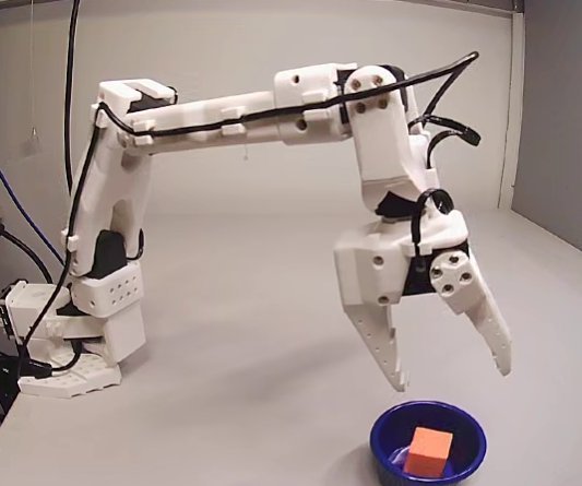 SO-101 arm dropping a cube into a blue cup