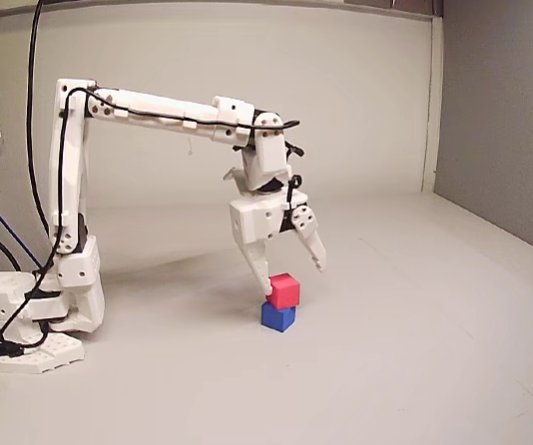 SO-101 arm stacking a cube on a blue cube